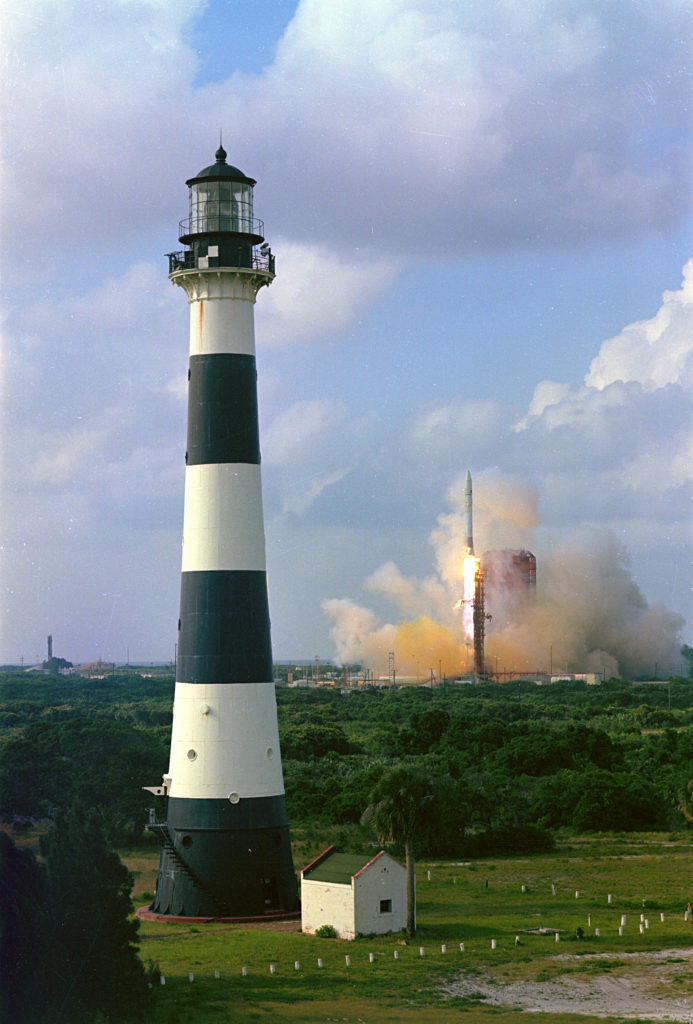 Rocket launch behind Cape Canaveral Lighthouse
